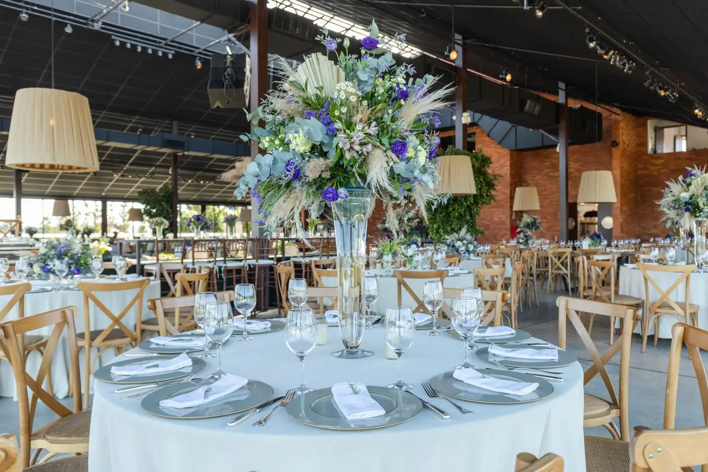 A long reception table set with flowers and glassware